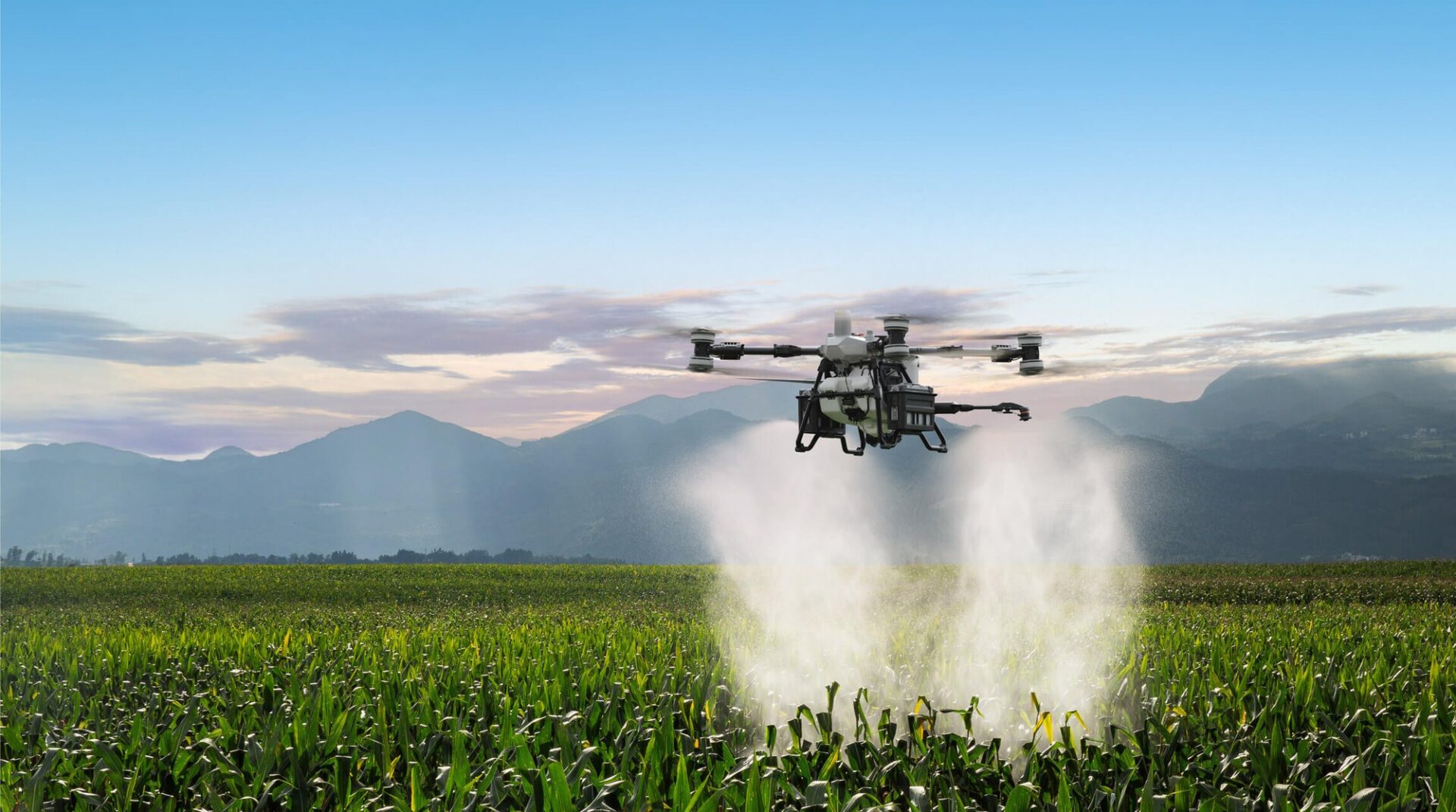 Oprysk pola DJI Agras T100 wykonuje oprysk pola u podnóża gór