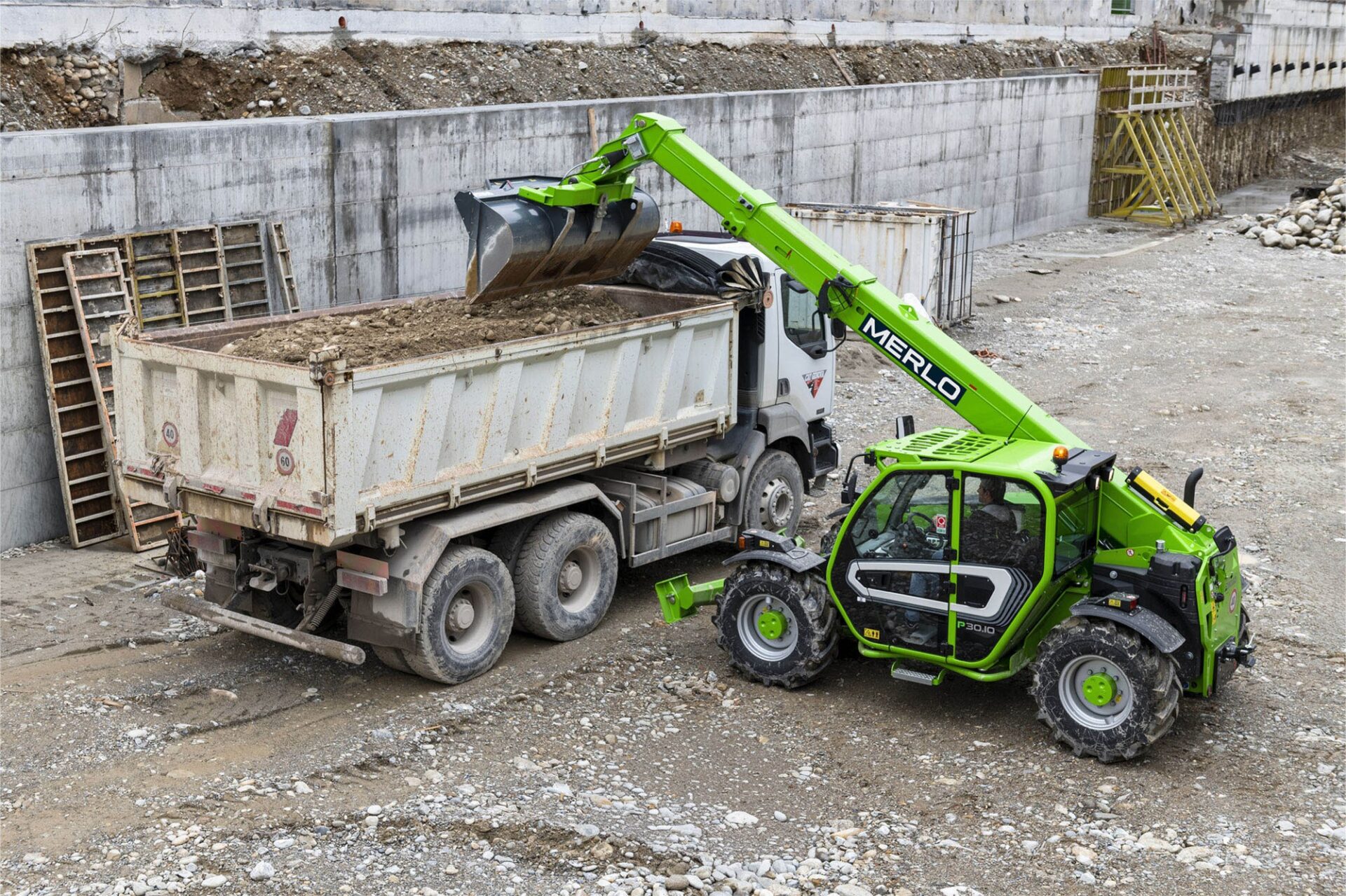 Merlo Panoramic P30.10 – stabilizowana ładowarka teleskopowa podczas załadunku wywrotki